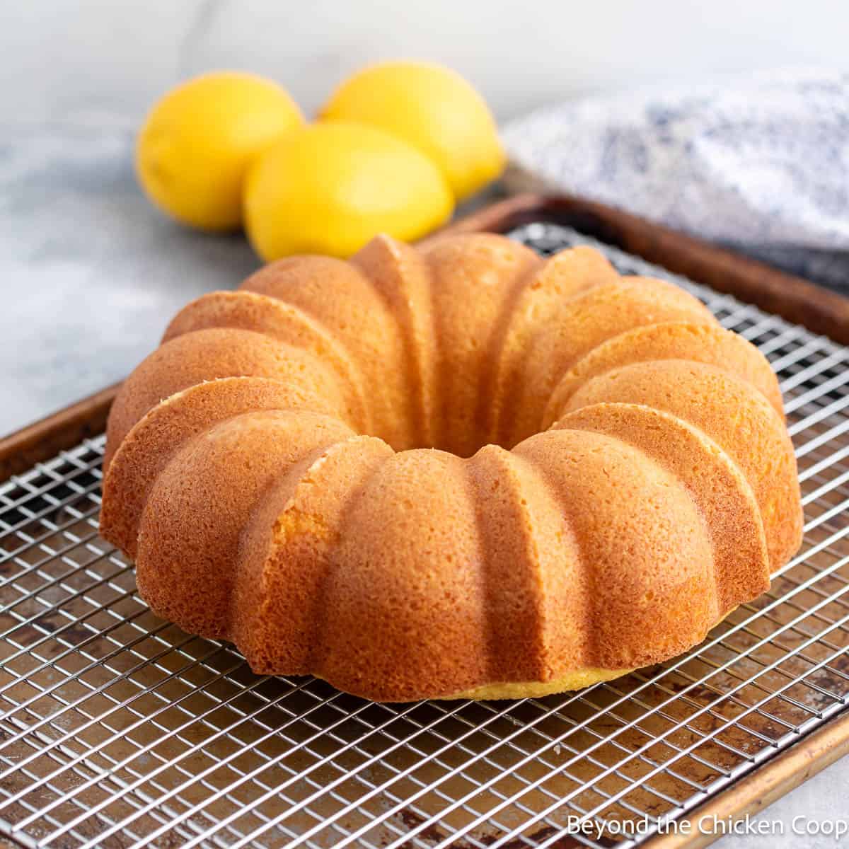 A lemon bundt cake on a cooling rack. 