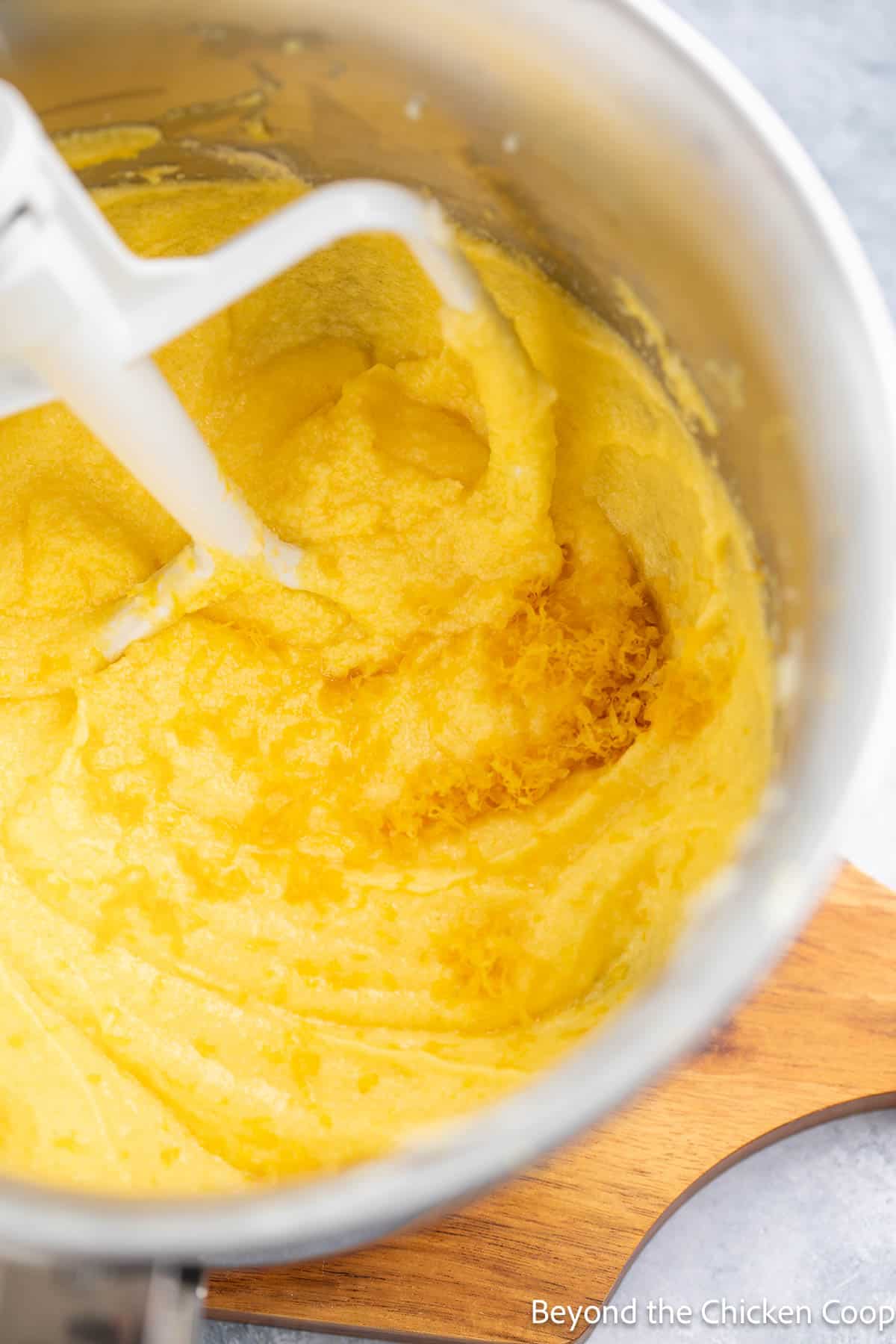 Adding lemon zest to cake batter. 