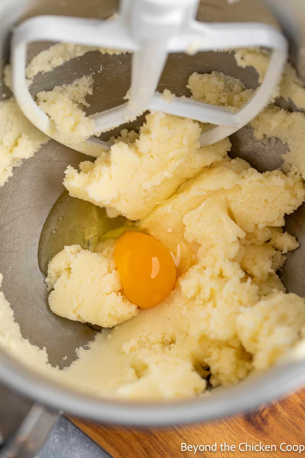 A mixing bowl with creamed butter and eggs. 