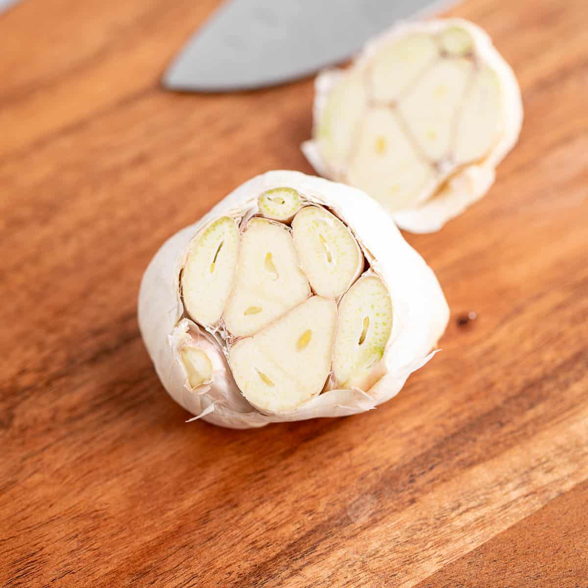 A head of garlic with the top cut off. 