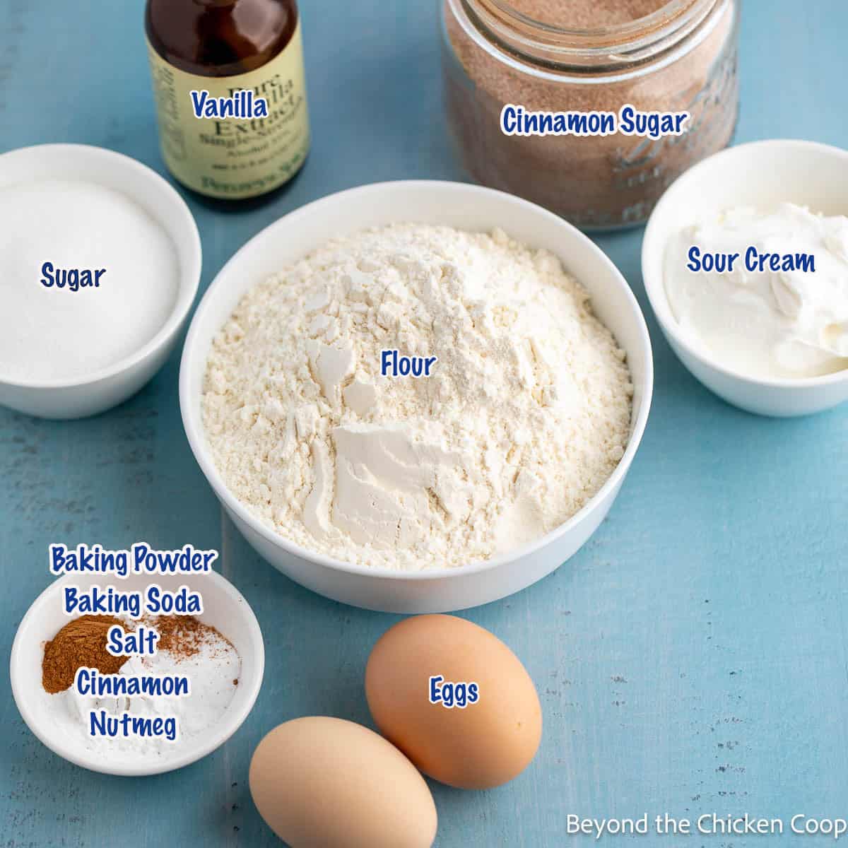 Small bowls filled with flour, sugar and other baking ingredients. 