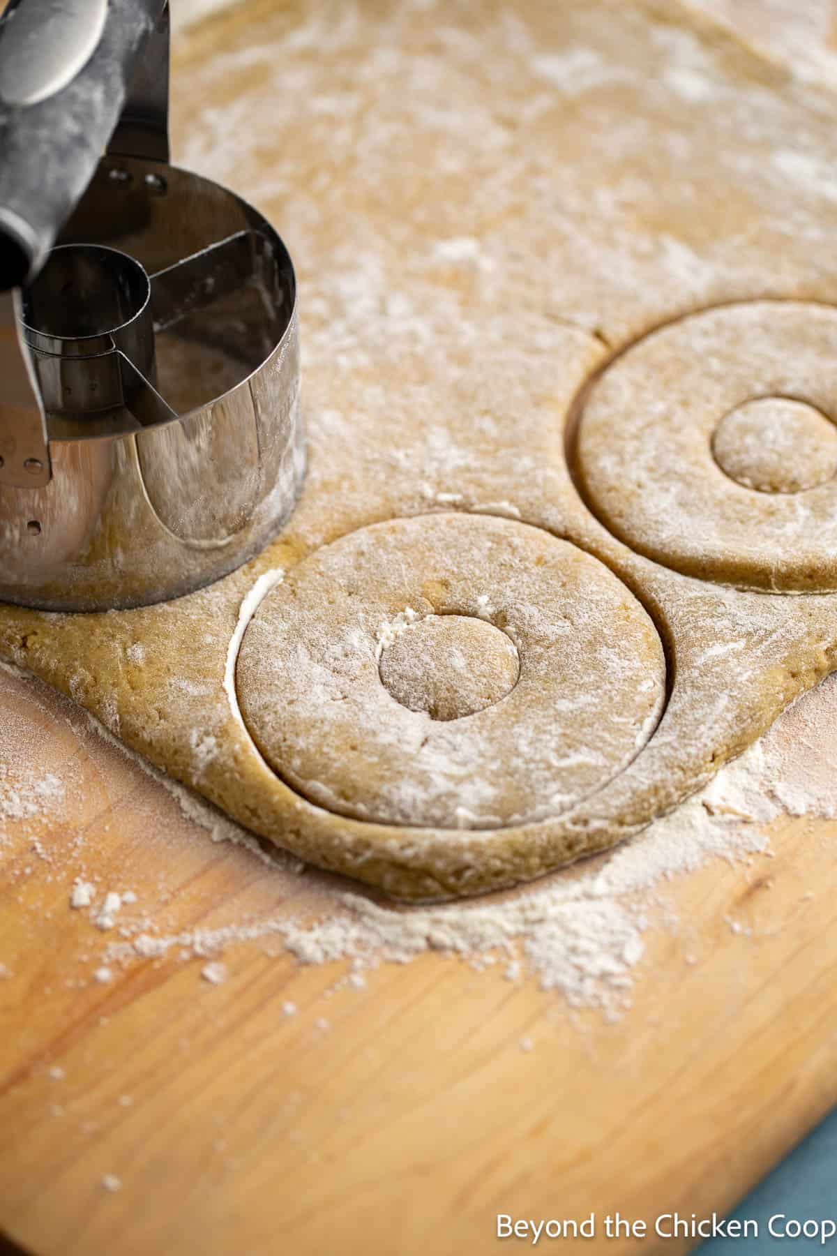 Cutting out donuts from dough. 