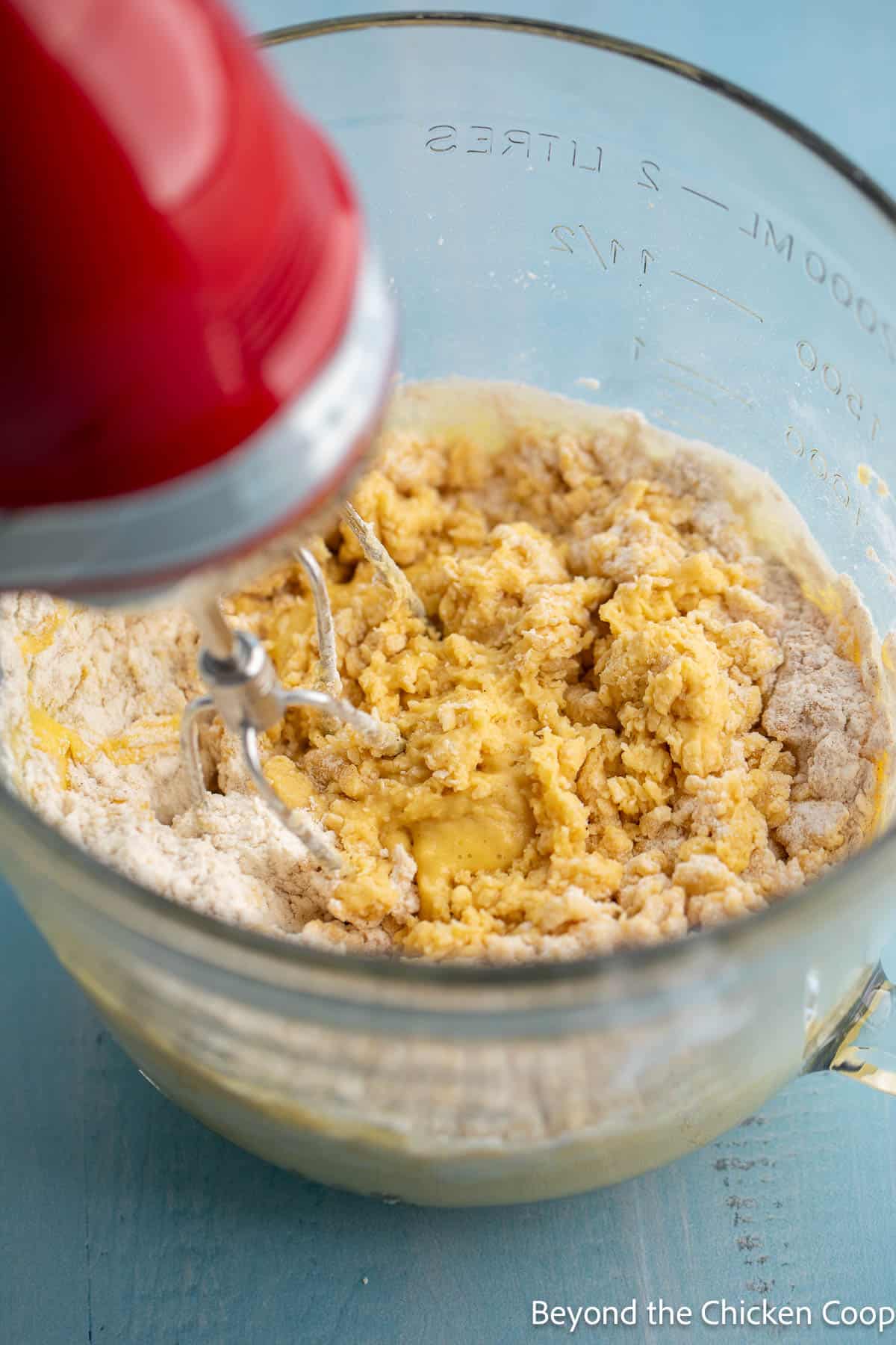 Adding flour to dough in a bowl. 