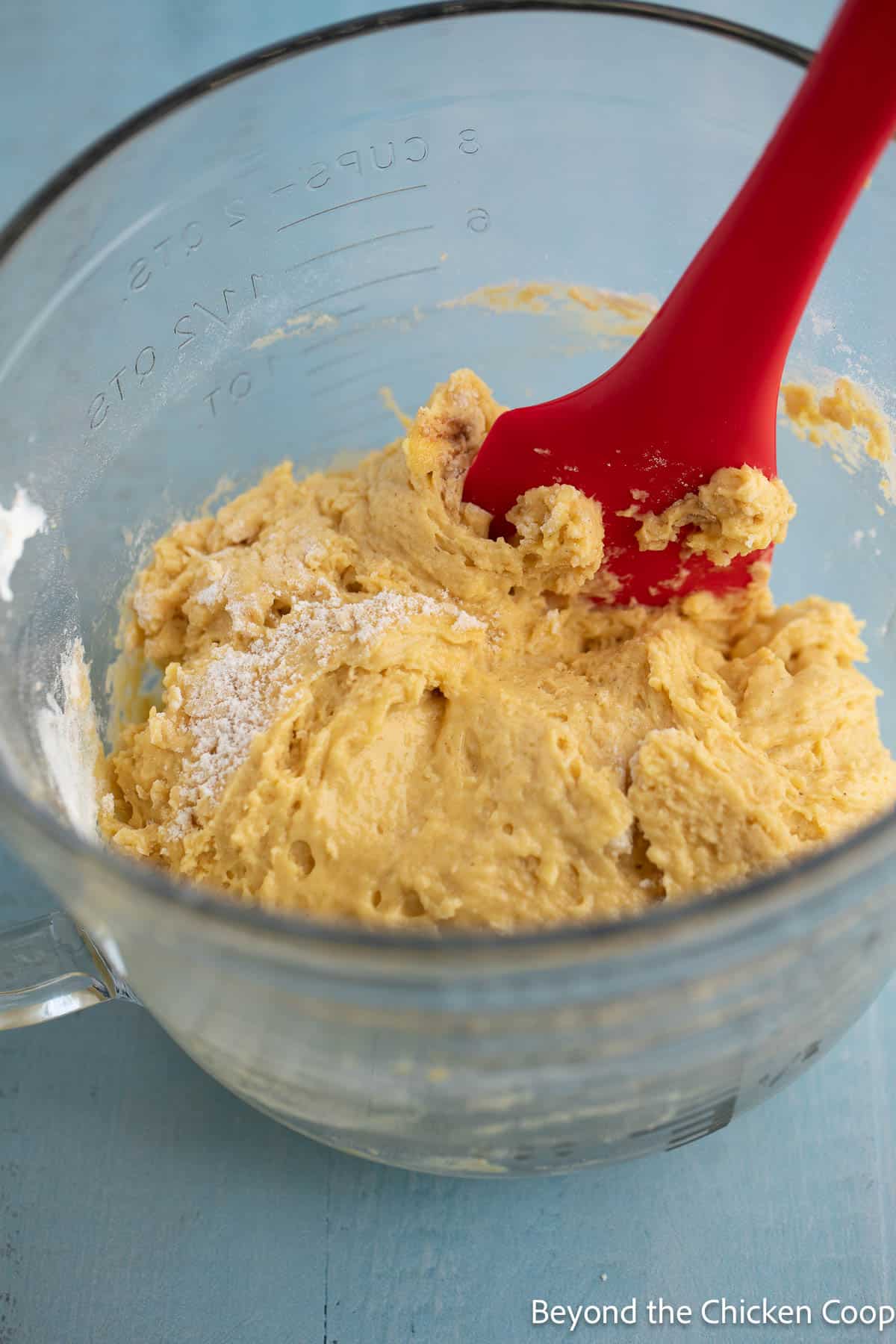 Folding flour into batter. 