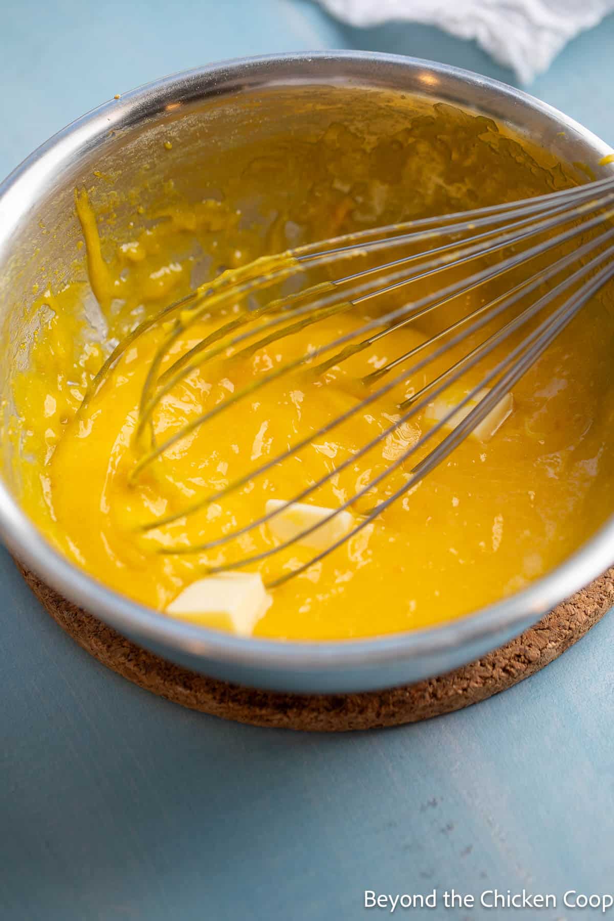 Whisking butter into warm lemon curd. 