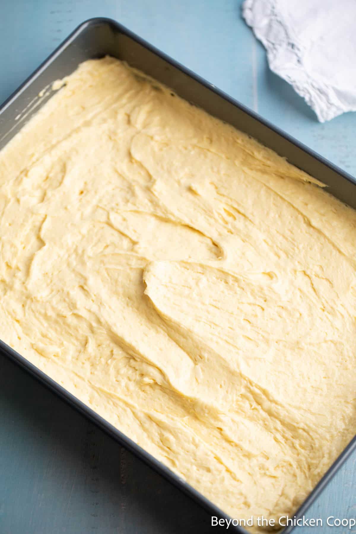 Cake batter in a rectangular cake pan. 