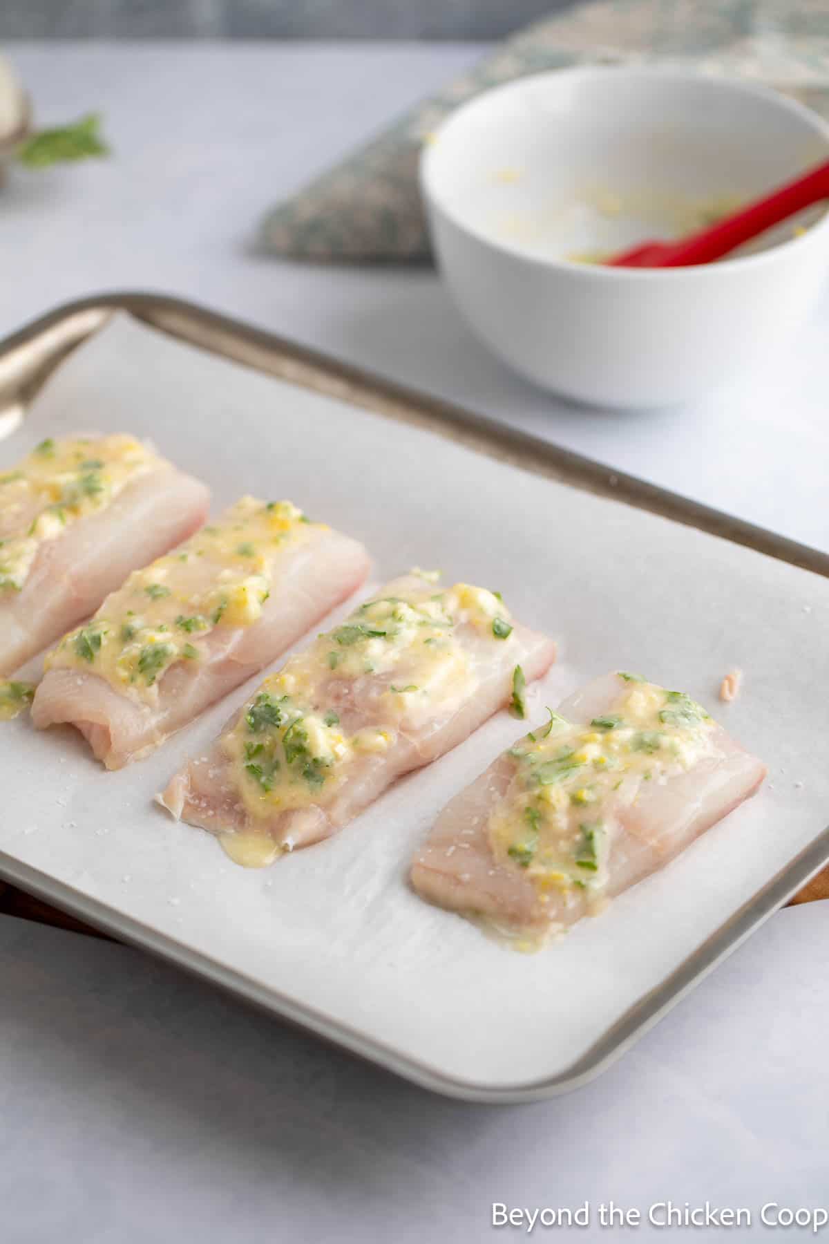 A butter mixture spread on top of halibut fillets. 