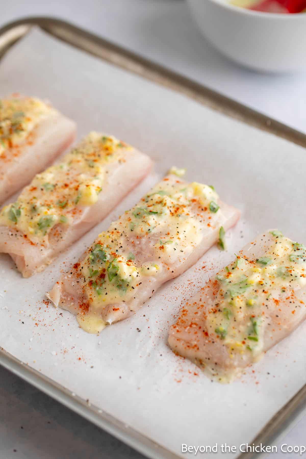 Halibut fillets topped with butter and paprika. 
