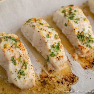 Baked halibut on a baking sheet.