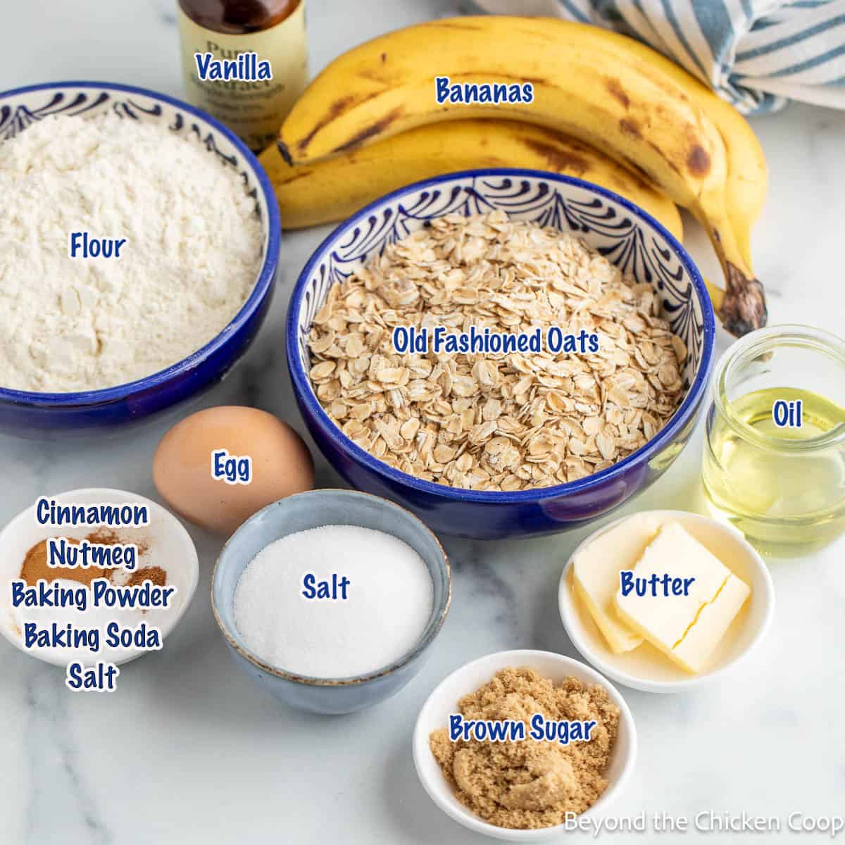Small bowls filled with ingredients for making banana oatmeal muffins.