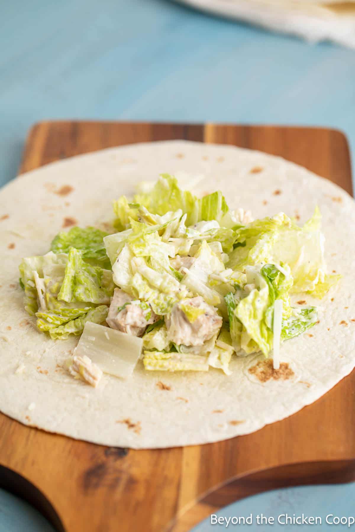 Caesar salad on a tortilla.
