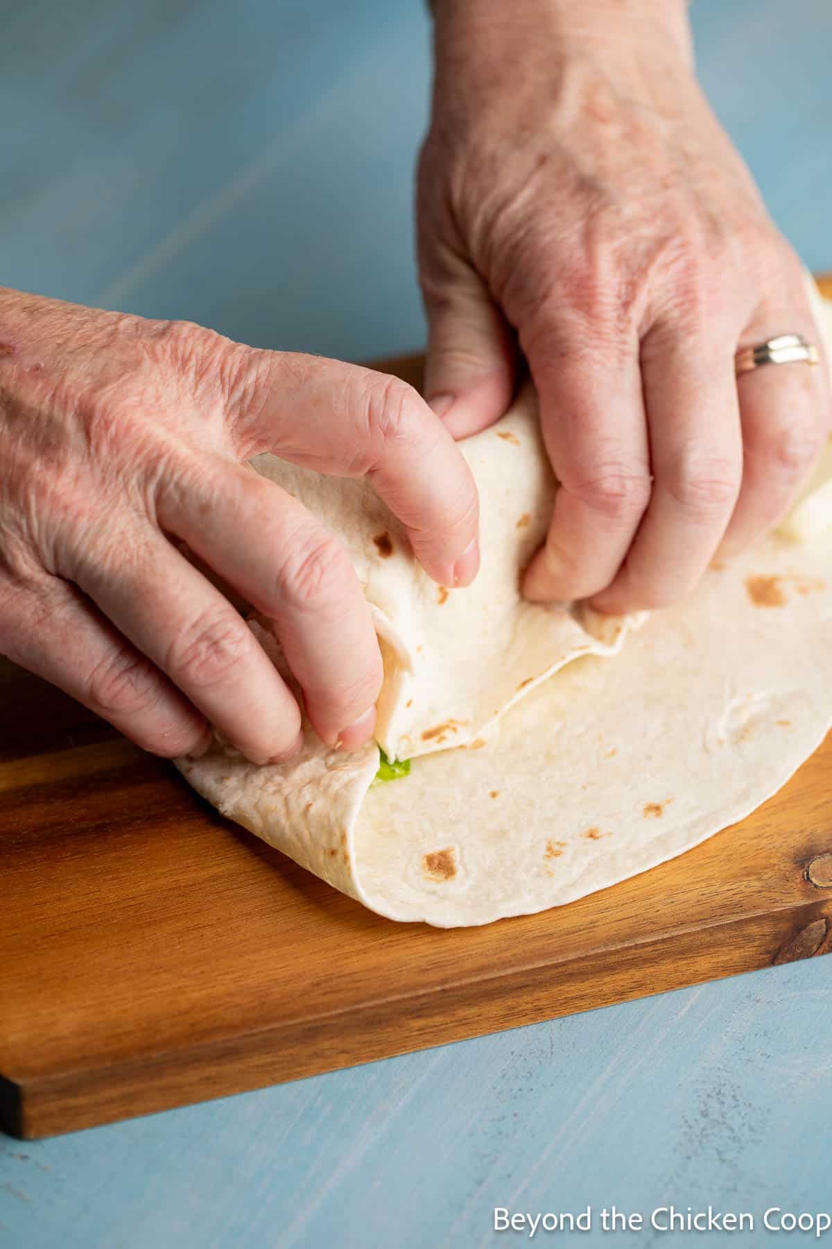 Wrapping a tortilla.