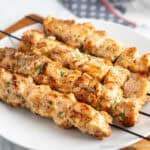 Garlic Parmesan Chicken Skewers on a white dinner plate.