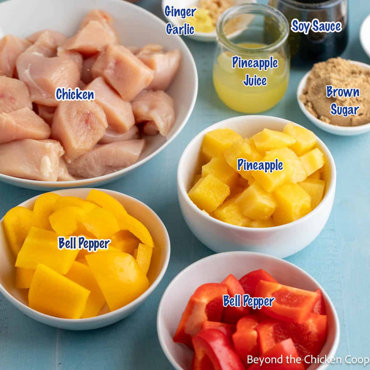 Bowls filled with chicken, bell peppers and pineapple. 