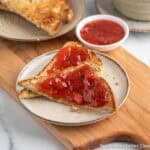 Strawberry rhubarb jam spread on a piece of toast.