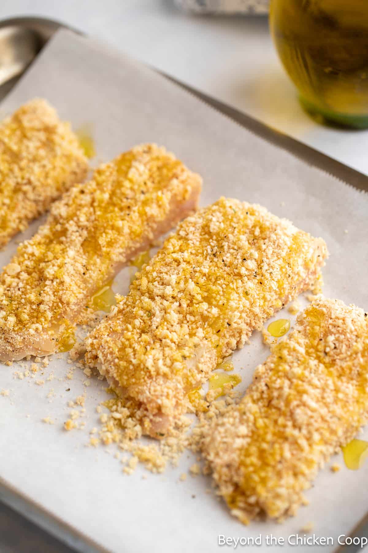 Breaded halibut on a baking sheet. 