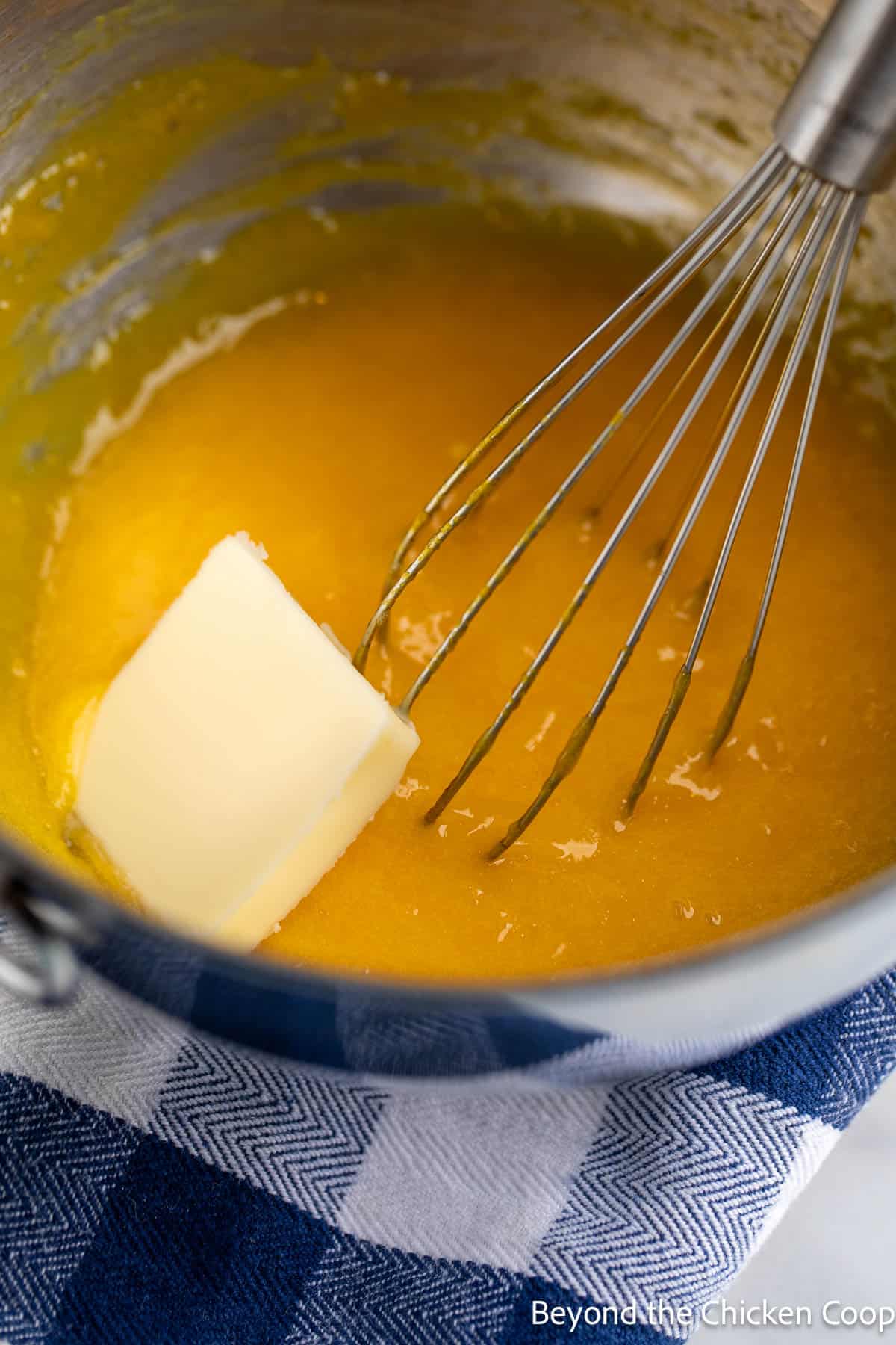 Whisking butter into lemon curd. 