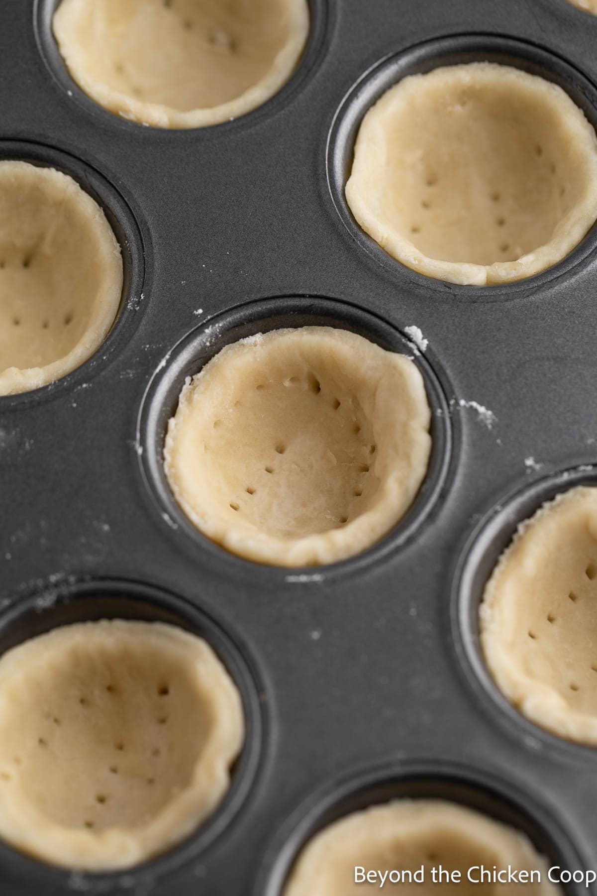 Mini pie crust with small holes in the crust. 