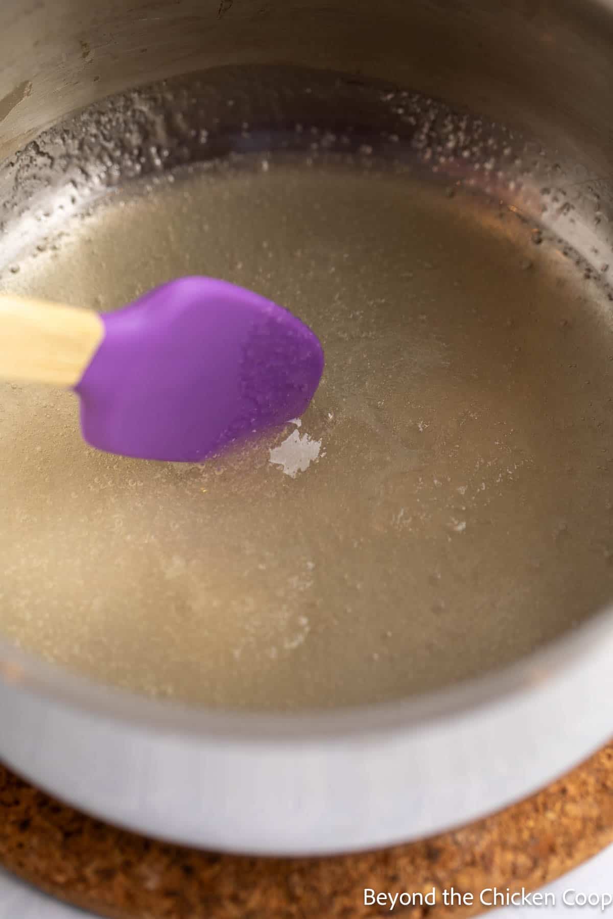Mixing gelatin into water in a small pot. 