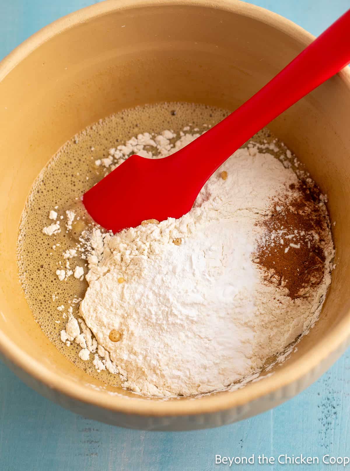 Adding flour to batter. 