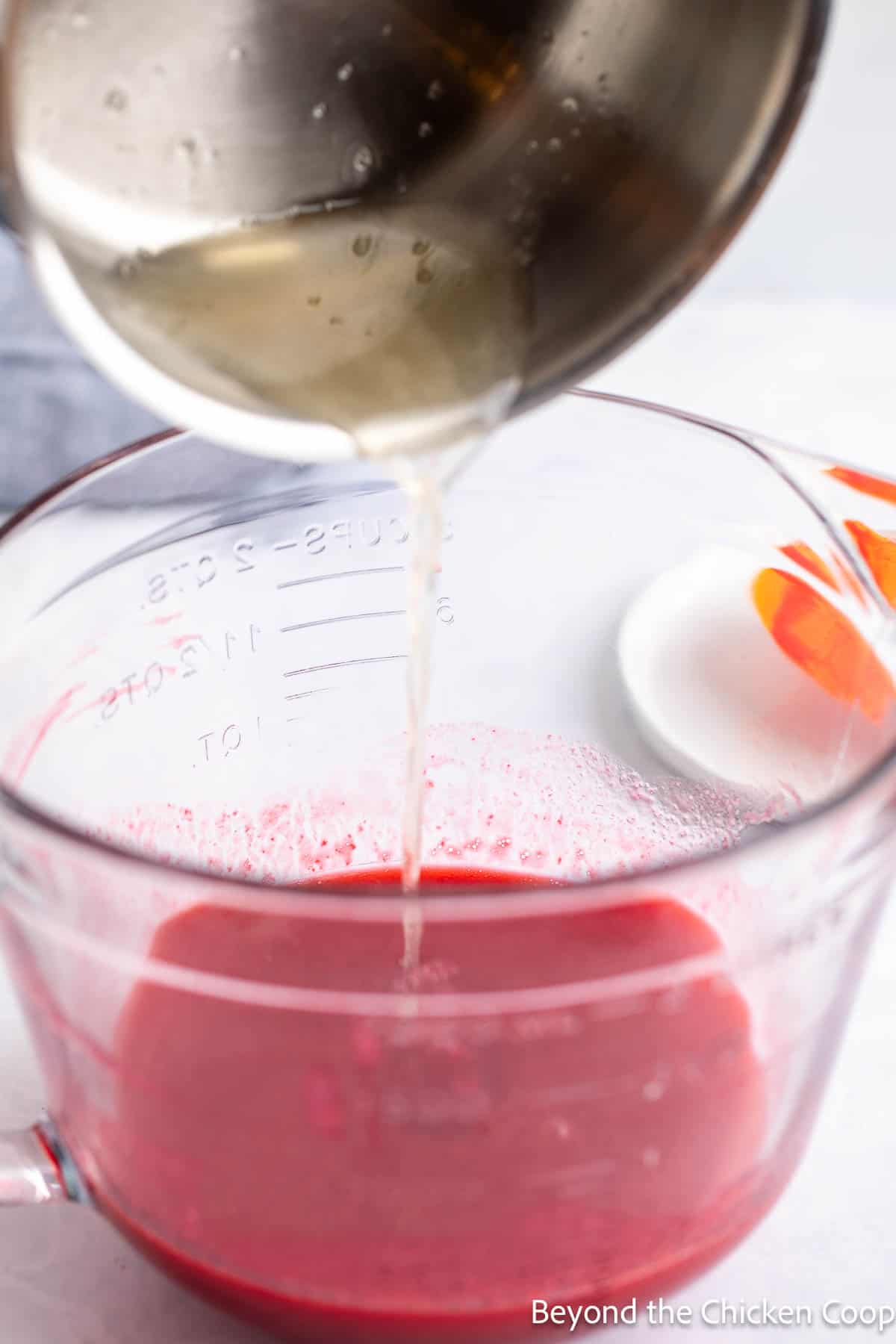 Adding the gelatin to raspberry puree. 