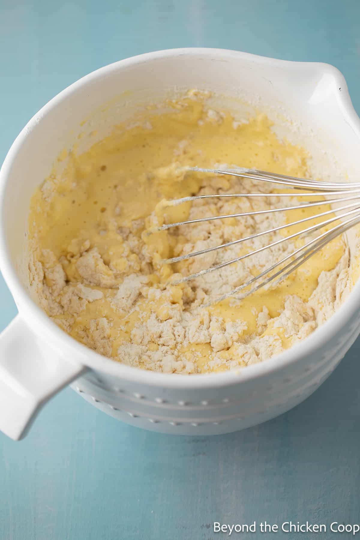 Thick waffle batter in a white mixing bowl.