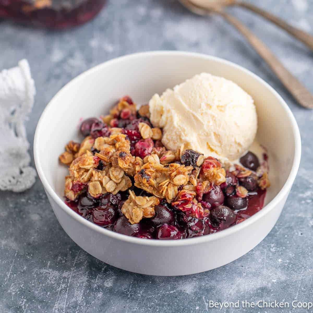Blueberry Crisp in a bowl with a scoop of ice cream.