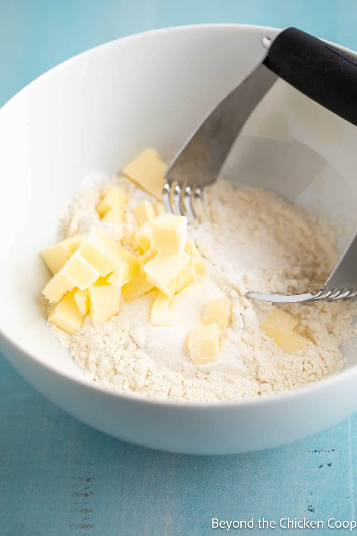Cubed butter in a bowl with flour. 