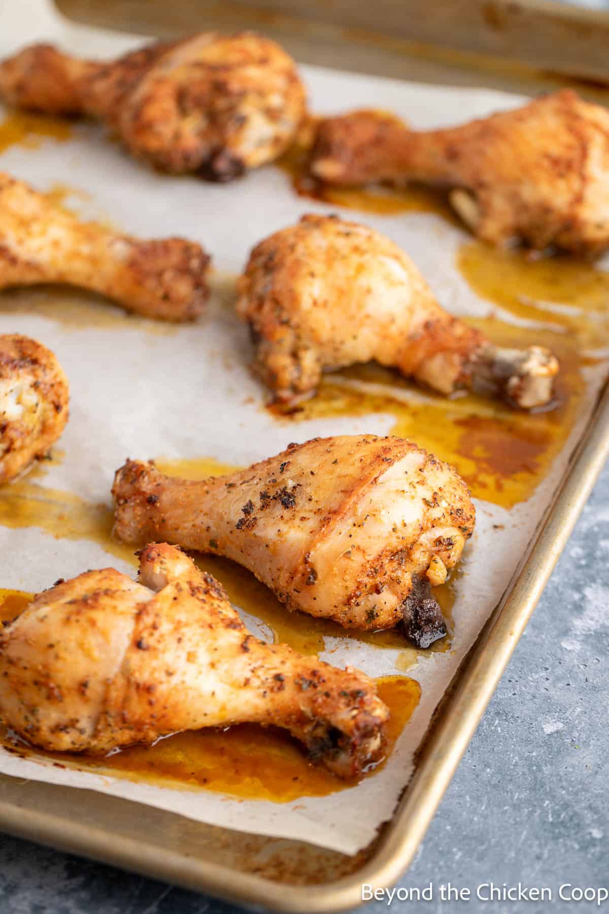 Baked drumsticks on a baking sheet. 