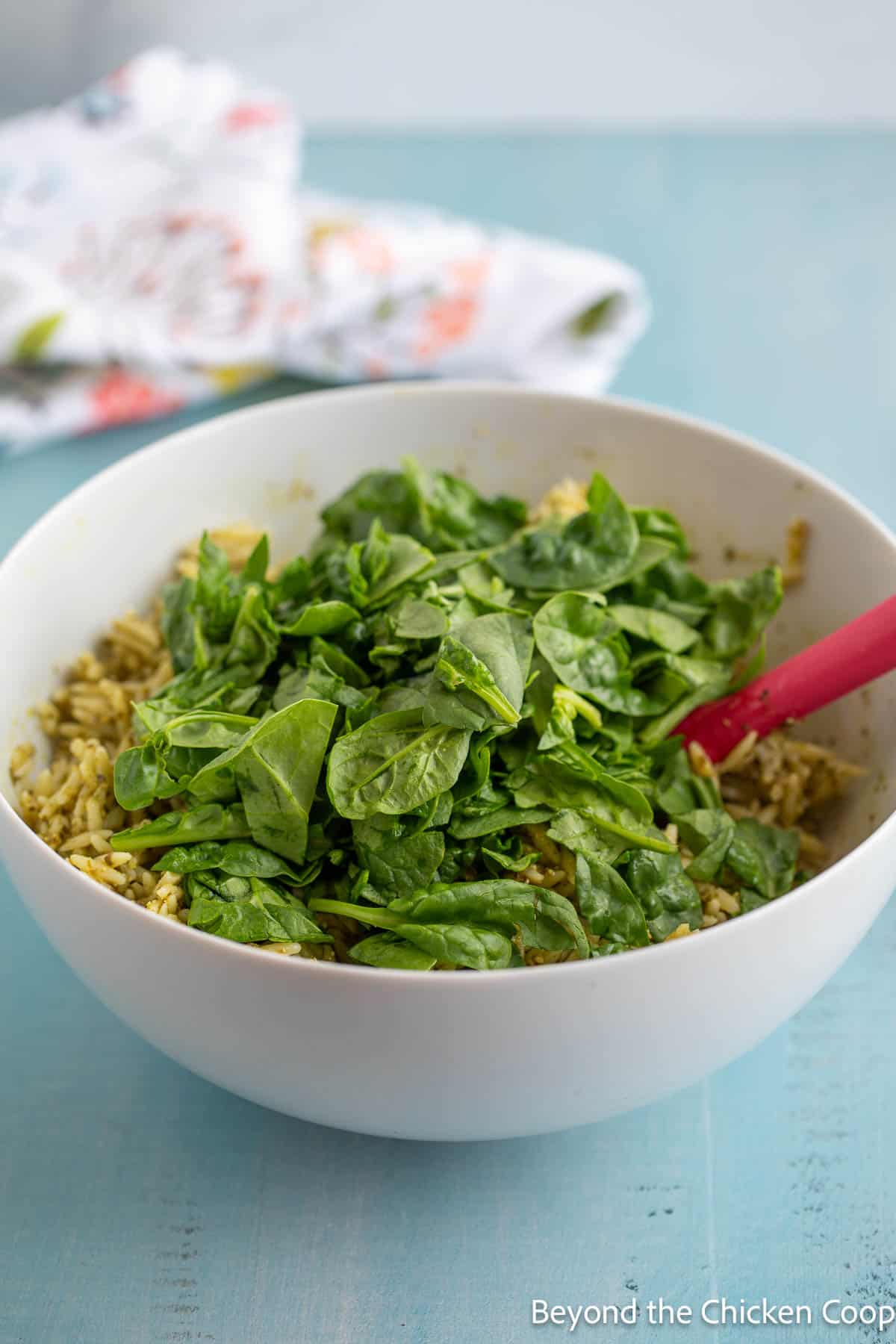 Baby spinach added to a bowl of pasta. 