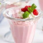 A glass ice cream jar filled with pink mousse.