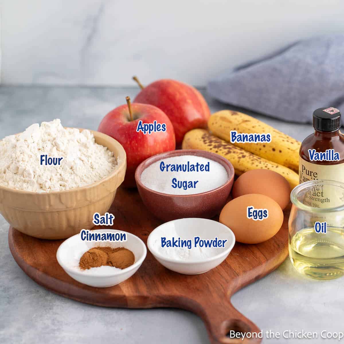 Ingredients in small bowls for making apple and banana muffins. 