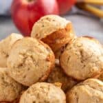 Banana Apple Muffins in a stack on a board.