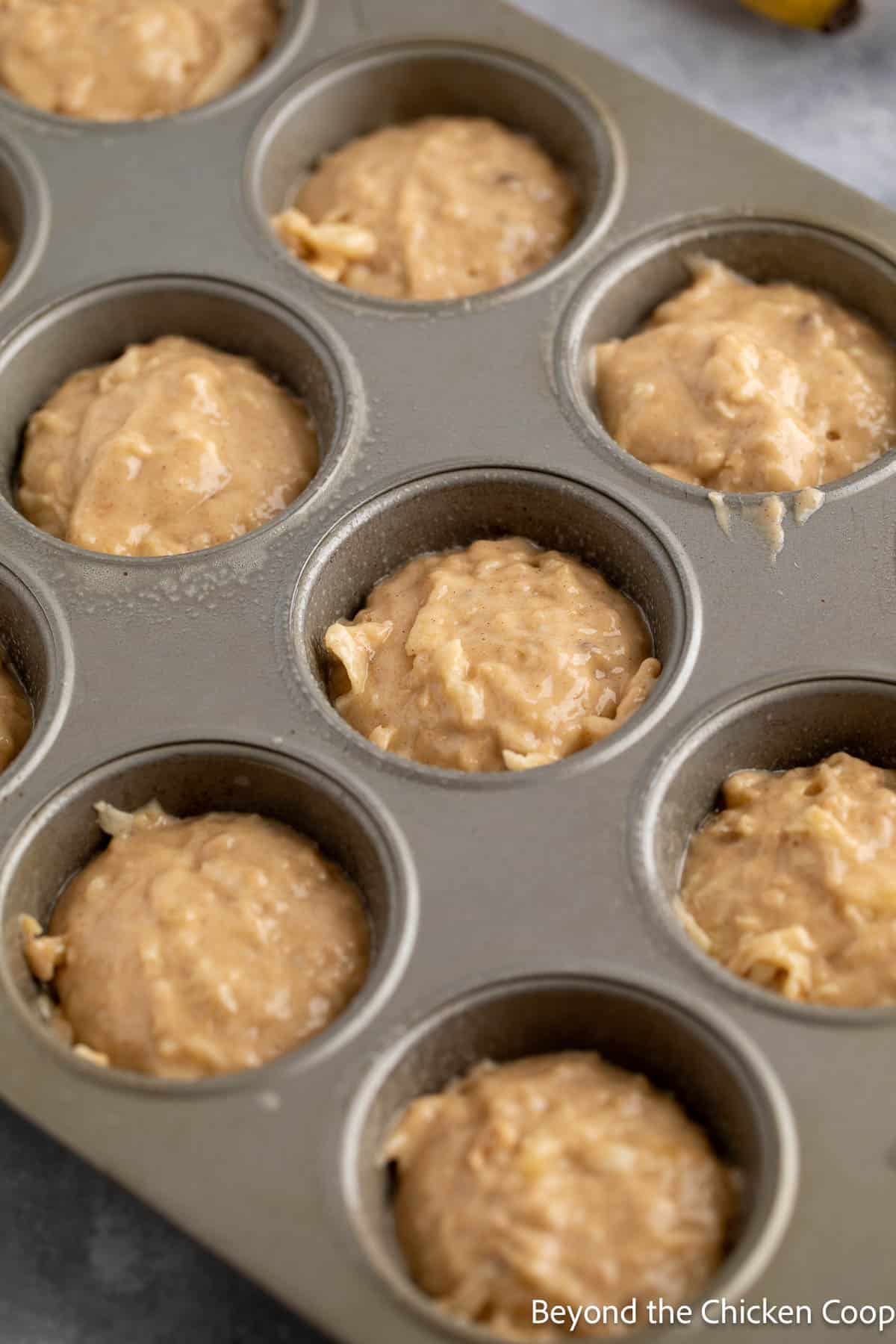 A muffin tin filled with batter.