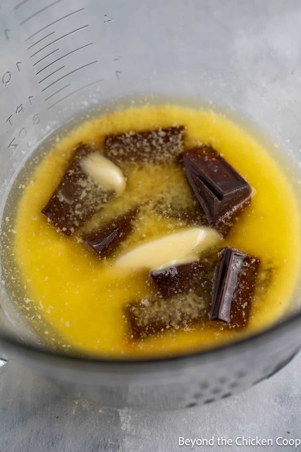 Butter and chocolate melting together in a bowl.