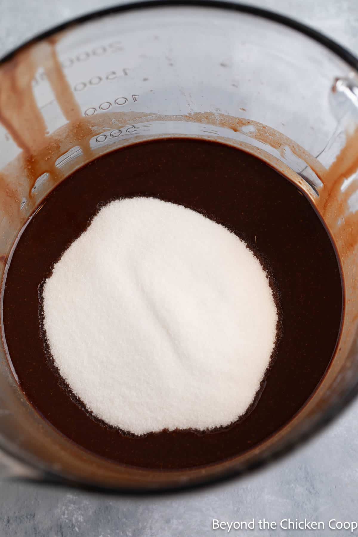 Sugar added to melted chocolate.
