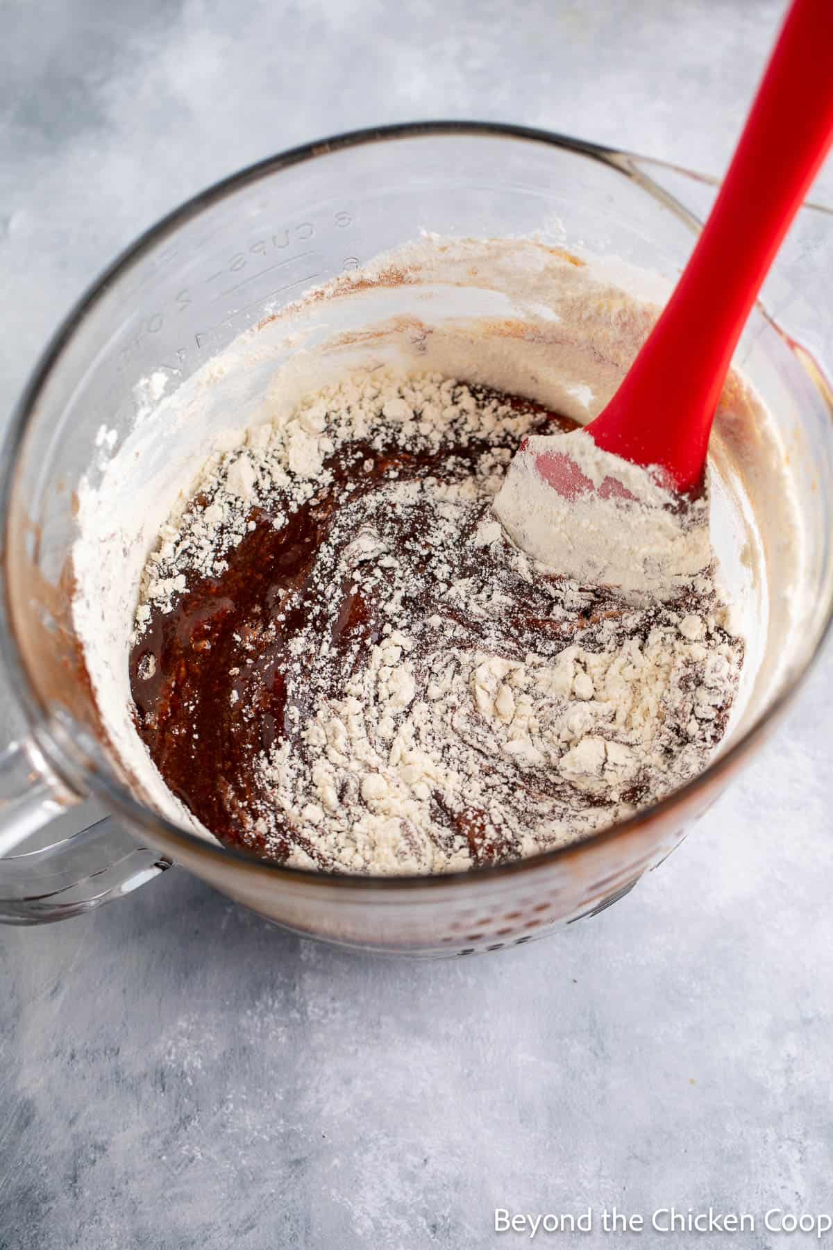 Folding flour into brownie batter.
