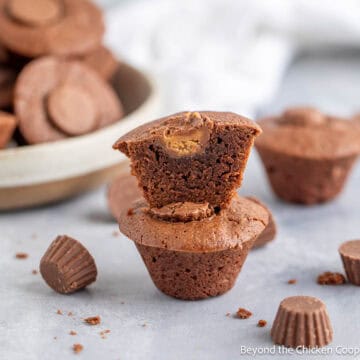 Brownie peanut butter cups stacked on a counter.