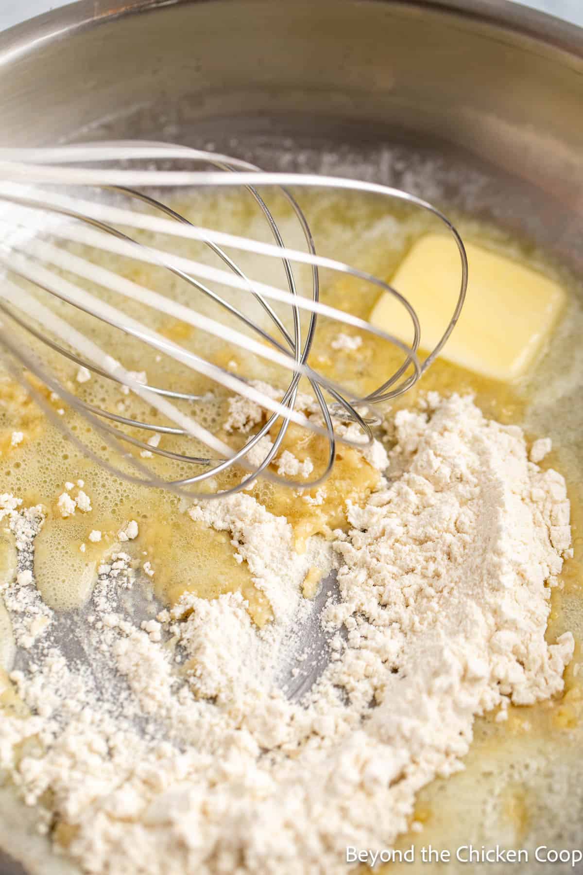 Mixing flour and butter together to make a roux. 
