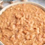 Creamy refried beans in a cream colored bowl.