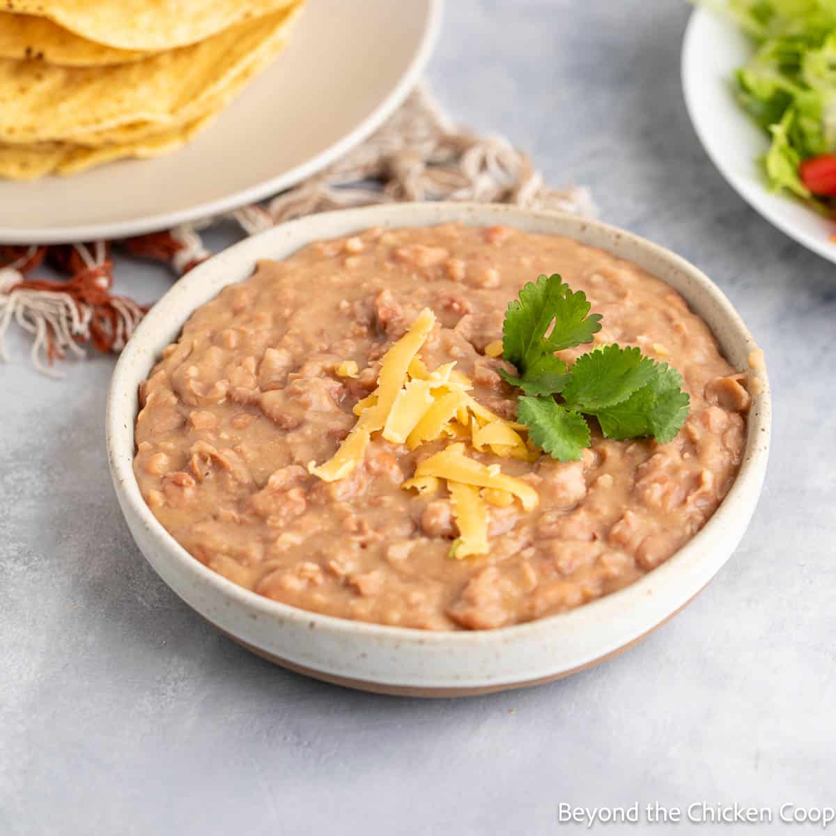 Refried beans topped with shredded cheese. 