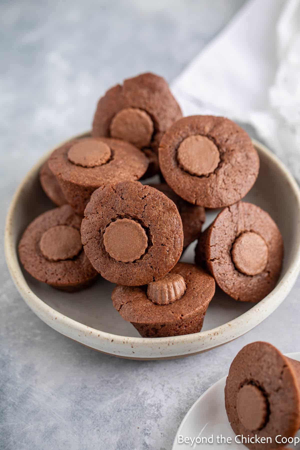 Mini peanut butter brownies stacked in a bowl. 
