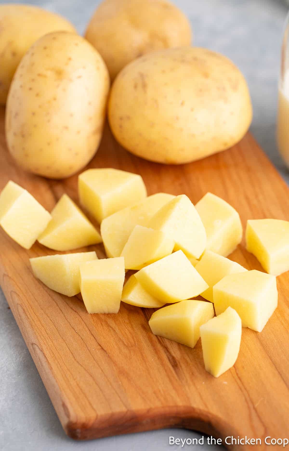 Chopped yellow potatoes on a board. 