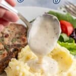 Pouring white gravy over mashed potatoes.