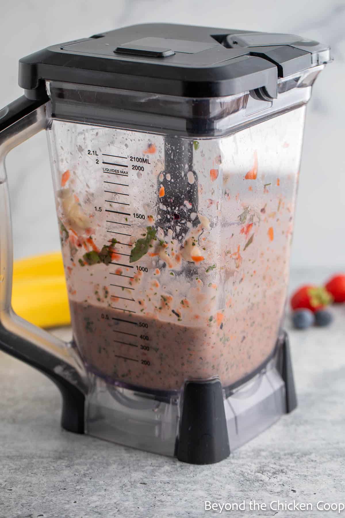Pureeing fruit and vegetables in a blender for a smoothie. 
