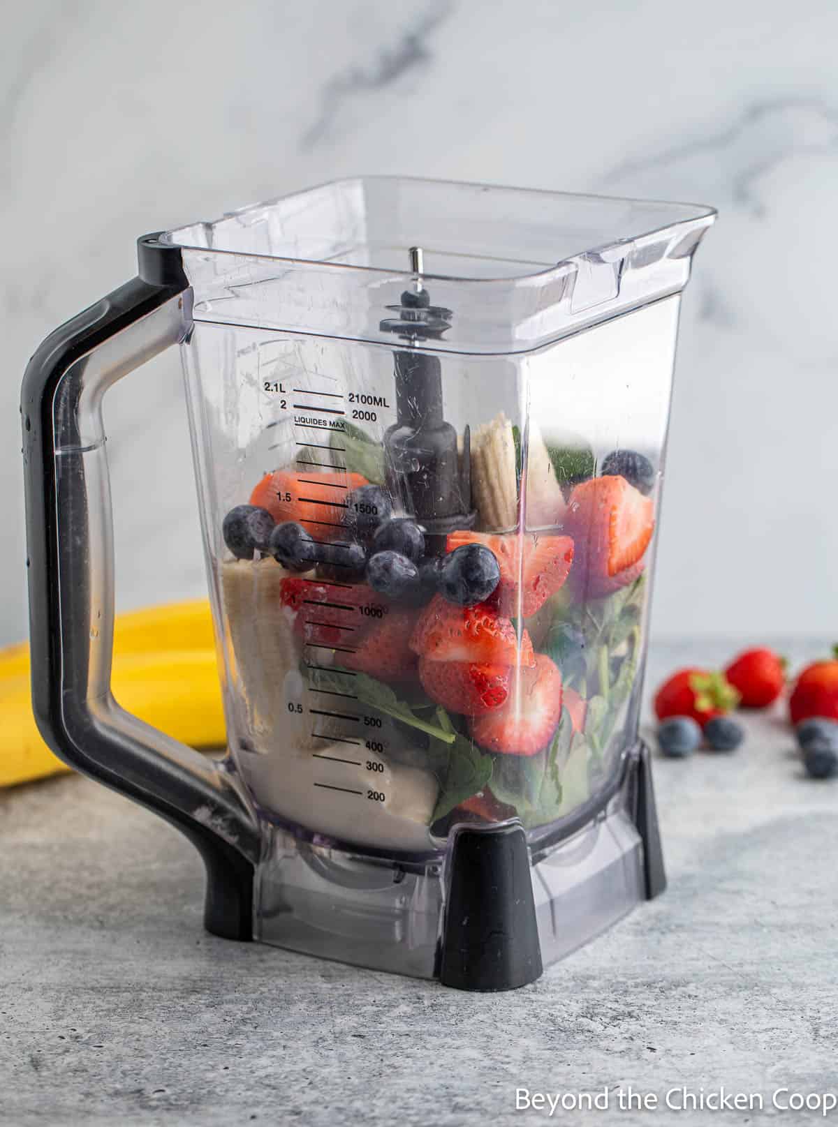 Fruit and veggies in a blender.