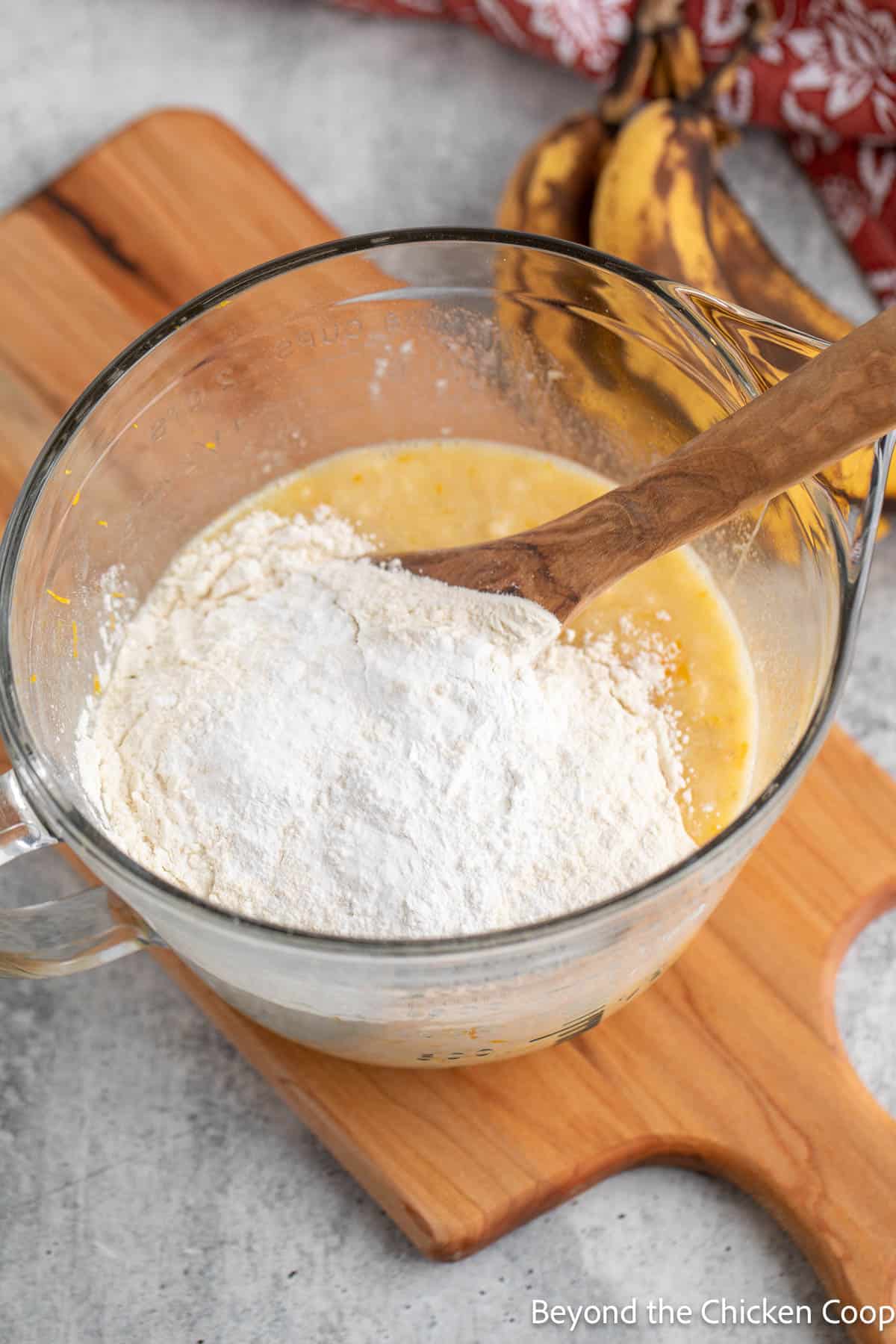 Flour added to a bowl. 