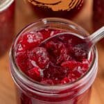 A canning jar filled with cranberry sauce.