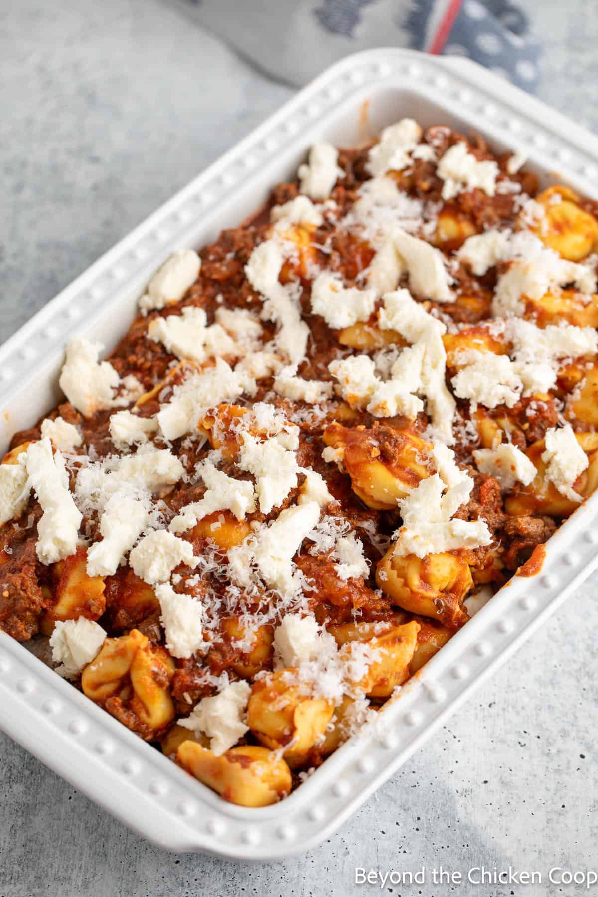 Tortellini casserole in a white dish. 