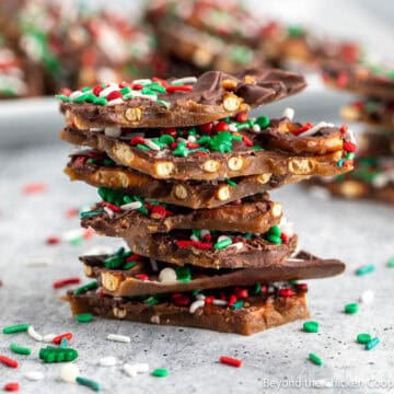 Pieces of chocolate caramel pretzel bark stacked together.